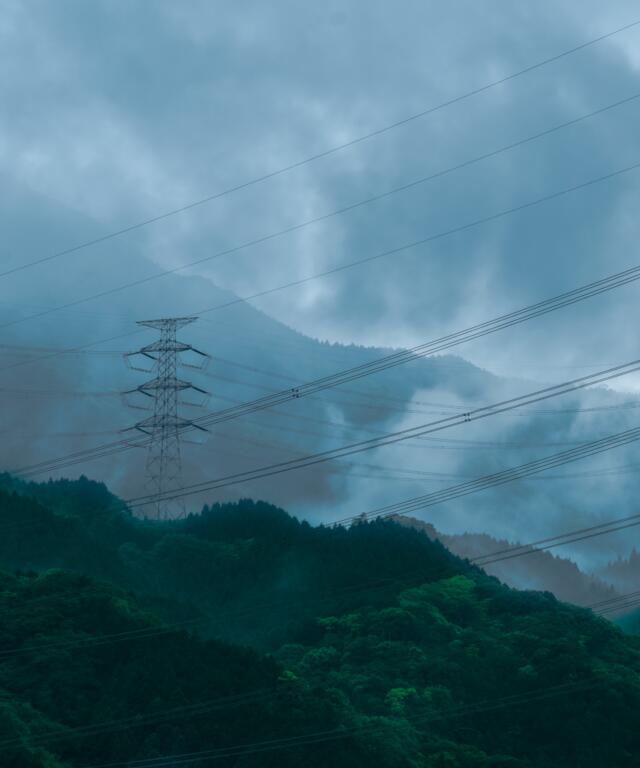 energy grid with green scenery around them