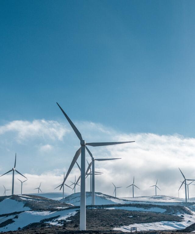 wind power station with snow on the ground